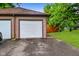 Detached two-car garage featuring white doors and a well-maintained exterior with an adjacent driveway at 1236 Central Ave, Indianapolis, IN 46202