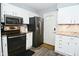 Modern kitchen with white cabinets, stainless steel appliances, and granite countertops at 1236 Central Ave, Indianapolis, IN 46202