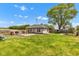 Large backyard featuring a privacy fence, mature trees, and green grass at 1237 W State Rd 38, Pendleton, IN 46064
