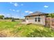Backyard featuring a small deck, green grass, and privacy fence at 1237 W State Rd 38, Pendleton, IN 46064