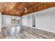 Bright living room featuring wood-paneled ceiling, light walls, and hardwood floors at 1237 W State Rd 38, Pendleton, IN 46064