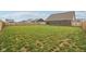 Spacious backyard with healthy green grass and a wood fence, perfect for outdoor activities at 1270 Shaw Ln, Shelbyville, IN 46176