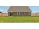 The backyard features a well-manicured lawn, four evenly spaced windows, and sliding glass door at 1270 Shaw Ln, Shelbyville, IN 46176