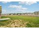 Large backyard featuring a green lawn, wood fence, and a small concrete patio at 1270 Shaw Ln, Shelbyville, IN 46176
