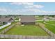 Aerial view displaying a large backyard with a wooden fence ensuring privacy in a Gathering-friendly neighborhood at 1270 Shaw Ln, Shelbyville, IN 46176