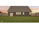 Back exterior shot highlighting a spacious, enclosed backyard perfect for outdoor activities at 1270 Shaw Ln, Shelbyville, IN 46176