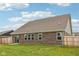 An expansive backyard featuring a well-maintained lawn and a sliding glass door for easy access at 1270 Shaw Ln, Shelbyville, IN 46176