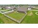 Aerial view showcasing backyard's privacy fence and a glimpse of neighborhood amenities at 1270 Shaw Ln, Shelbyville, IN 46176