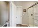 Bathroom featuring a toilet, a shower with a glass door, and laminate wood flooring at 1270 Shaw Ln, Shelbyville, IN 46176