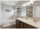 Bright bathroom showcasing a double sink vanity, large mirror, and separate tub and shower at 1270 Shaw Ln, Shelbyville, IN 46176