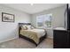 Bright bedroom featuring neutral paint, carpet, window overlooking the neighborhood, and dark furniture at 1270 Shaw Ln, Shelbyville, IN 46176