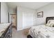 Bedroom with gray walls and closet door, including a dresser, framed art, and view into the hallway at 1270 Shaw Ln, Shelbyville, IN 46176