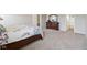 Cozy bedroom features a floral-patterned quilt, dresser with mirror, and access to the bathroom at 1270 Shaw Ln, Shelbyville, IN 46176