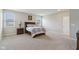 Large bedroom with gray walls and carpet featuring bedside lamps, windows, and dresser at 1270 Shaw Ln, Shelbyville, IN 46176