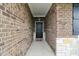 Covered entryway showcases the brick facade and leads to a black front door at 1270 Shaw Ln, Shelbyville, IN 46176