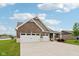 Charming brick home featuring a large three car garage and well-manicured lawn at 1270 Shaw Ln, Shelbyville, IN 46176