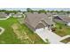 Aerial view highlighting a home's three-car garage, driveway, landscaping, and ample green space at 1270 Shaw Ln, Shelbyville, IN 46176