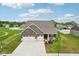 Aerial view of a home featuring a three car garage and meticulously manicured landscaping at 1270 Shaw Ln, Shelbyville, IN 46176