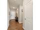 Neutral hallway boasts wood floors and white trim, creating a bright transition space at 1270 Shaw Ln, Shelbyville, IN 46176