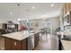Island kitchen flows into living area with stainless appliances at 1270 Shaw Ln, Shelbyville, IN 46176