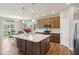 Open kitchen design with a central island, modern appliances, and a view of the dining area at 1270 Shaw Ln, Shelbyville, IN 46176