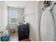 Bright laundry room with gray walls, flooring, window, and side-by-side washer and dryer at 1270 Shaw Ln, Shelbyville, IN 46176