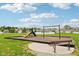 View of the community playground with a slide, swings, and seating area for residents at 1270 Shaw Ln, Shelbyville, IN 46176