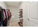 Walk-in closet with shelving for shoes and clothing racks, and door at 1270 Shaw Ln, Shelbyville, IN 46176