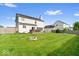 The backyard has a stone firepit and green grass at 12832 Broncos Dr, Fishers, IN 46037