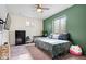 Bright bedroom boasts natural light, green accent wall, and a ceiling fan at 12832 Broncos Dr, Fishers, IN 46037