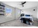 Bedroom featuring two windows, a ceiling fan, and built-in storage shelves at 12832 Broncos Dr, Fishers, IN 46037