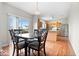 Cozy dining area adjacent to kitchen with wood floors, access to the backyard, and seating for four at 12832 Broncos Dr, Fishers, IN 46037