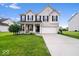 Charming two-story home featuring brick accents, a well-manicured lawn, and an attached two-car garage at 12832 Broncos Dr, Fishers, IN 46037