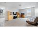 Spacious living room boasts carpet and cabinets for storage, with a gray couch at 12832 Broncos Dr, Fishers, IN 46037