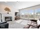 Bright living room featuring a fireplace, large windows, and comfortable sofas for Gathering and guests at 12832 Broncos Dr, Fishers, IN 46037