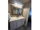 Bathroom vanity with white cabinets, modern countertop, framed mirror and views to the main bedroom at 1304 Crescent Dr, Greenwood, IN 46143