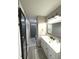Well-lit bathroom with a stylish vanity, mirror, and shower with gray accents at 1304 Crescent Dr, Greenwood, IN 46143