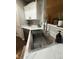 Close-up of a stainless steel kitchen sink with marble countertops and modern faucet at 1304 Crescent Dr, Greenwood, IN 46143