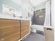 Bathroom with a single sink vanity with wood cabinets and shower-tub combo at 1409 Spann Ave, Indianapolis, IN 46203