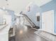 Bright entryway with hardwood floors, modern staircase, and stylish decor at 1409 Spann Ave, Indianapolis, IN 46203