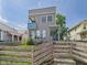 Eye-catching two-story home with a small balcony, accented by a charming wooden fence and green lawn at 1409 Spann Ave, Indianapolis, IN 46203