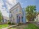 Modern two-story home with a small balcony, checkered flag, and a well-kept lawn framed by a rustic wooden fence at 1409 Spann Ave, Indianapolis, IN 46203
