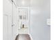 Hallway view leading to a well-lit bathroom with modern fixtures, providing a clean and functional space at 1409 Spann Ave, Indianapolis, IN 46203