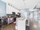 Modern kitchen featuring white cabinetry, pendant lighting, a breakfast bar, and open access to living area at 1409 Spann Ave, Indianapolis, IN 46203