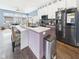 Modern kitchen with stainless steel appliances, a center island, and an adjacent sitting area at 1409 Spann Ave, Indianapolis, IN 46203