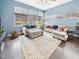 Inviting living room with large windows, plush seating, stylish area rug, and rich hardwood floors at 1409 Spann Ave, Indianapolis, IN 46203