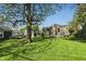 This beautiful backyard features a large tree with a full lawn and plenty of room for activities at 1515 S Emerson Ave, Indianapolis, IN 46203