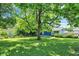 This beautiful backyard features a large tree with a full lawn with plenty of room to play at 1515 S Emerson Ave, Indianapolis, IN 46203