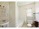 A compact bathroom with a tub, toilet, and small sink at 1515 S Emerson Ave, Indianapolis, IN 46203