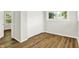 Comfortable bedroom featuring wood-look floors, bi-fold closet, and plenty of natural light at 1515 S Emerson Ave, Indianapolis, IN 46203